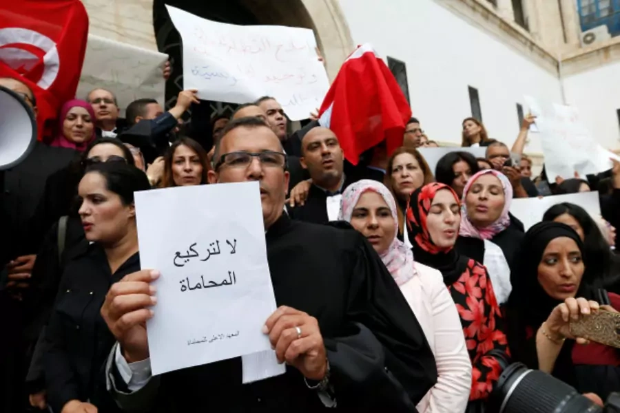 Tunisian lawyers gather as they demonstrate against the government's proposed new taxes, near the courthouse, in Tunis, Tunisia (Zoubeir Souissi/Reuters).