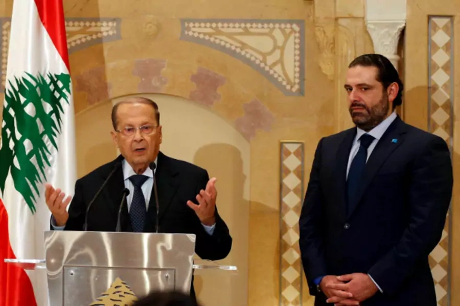 Christian politician and FPM founder Michel Aoun (L) talks during a news conference next to Lebanon's former prime minister Saad al-Hariri after he said he will back Aoun to become president in Beirut, Lebanon (Mohamed Azakir).