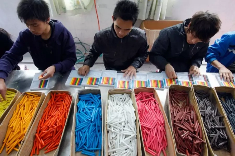 Migrant workers categorize crayons at a toy factory in Dongguan, Guangdong province March 9, 2010. South China's export strong... wages, but they are not as severe as reported by the media, provincial Communist Party boss Wang Yang said (Reuters/Joe Tan).