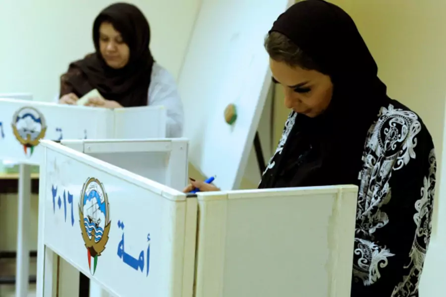 Kuwaiti women cast their votes during parliamentary election in a polling station in Kuwait City, Kuwait (Stringer/Reuters).