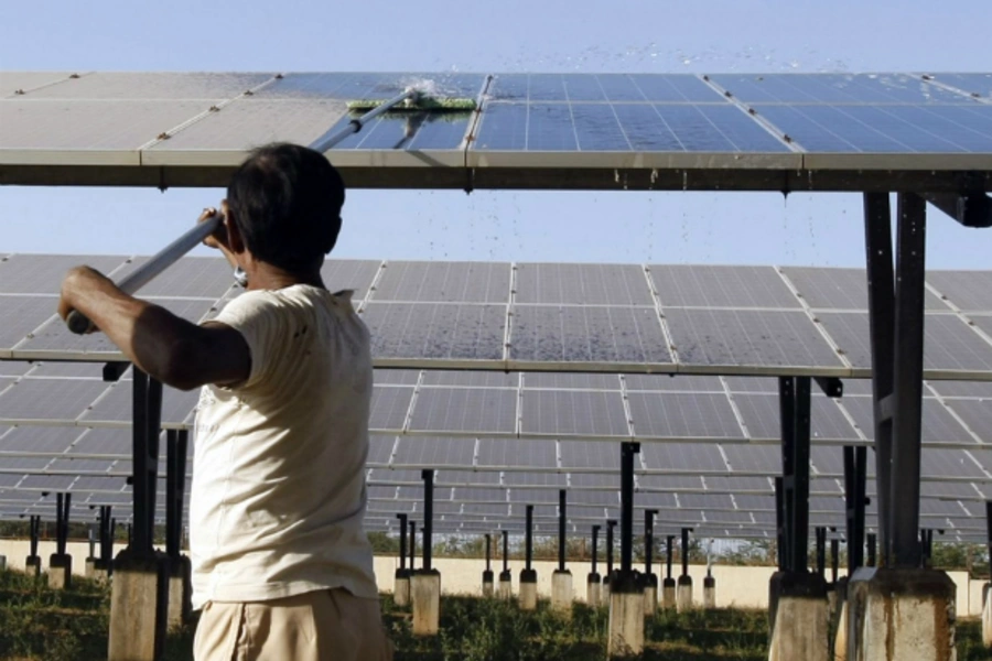 A worker cleans photovoltaic solar panels inside a solar power plant at Raisan village near Gandhinagar, in the western Indian state of Gujarat (Reuters/Amit Dave)