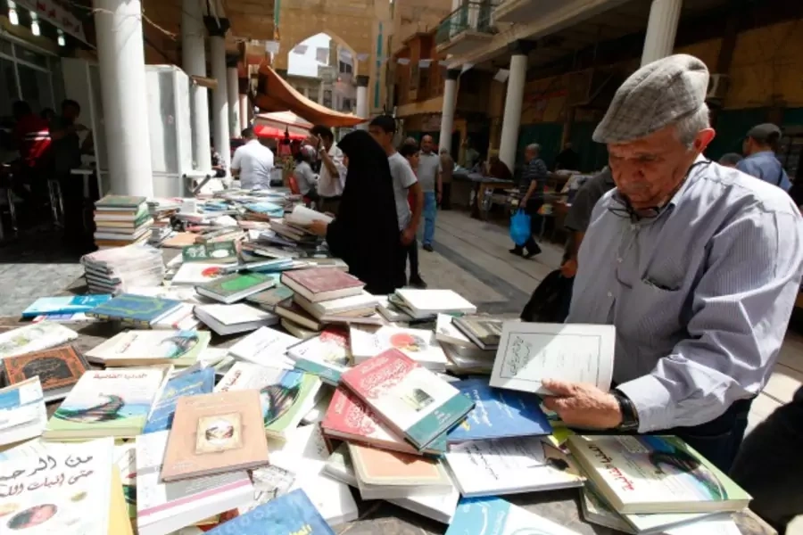 Residents shop for books at Mutanabi Street in Baghdad (Ahmed Saad/Reuters).