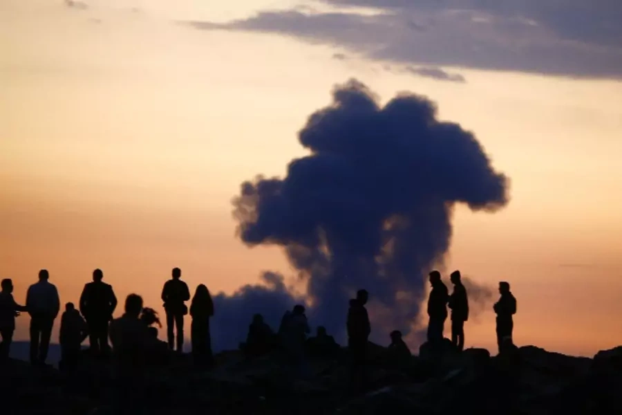 Kurds watch smoke rise