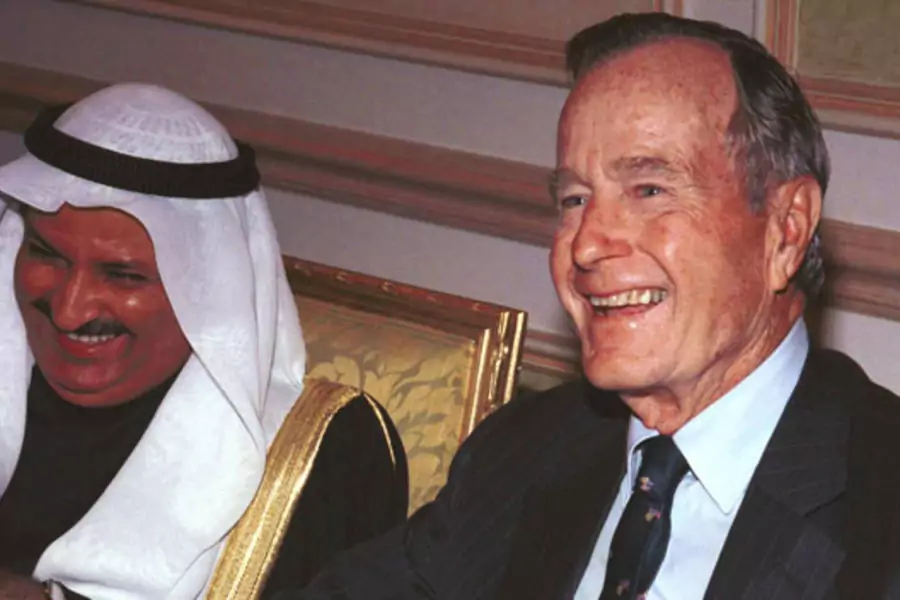 Former President George Bush, visiting Kuwait to mark the country's tenth Liberation Day, laughs with the Kuwaiti Minister for Cabinet Affairs in February 2001. (Stephanie McGehee/courtesy Reuters)