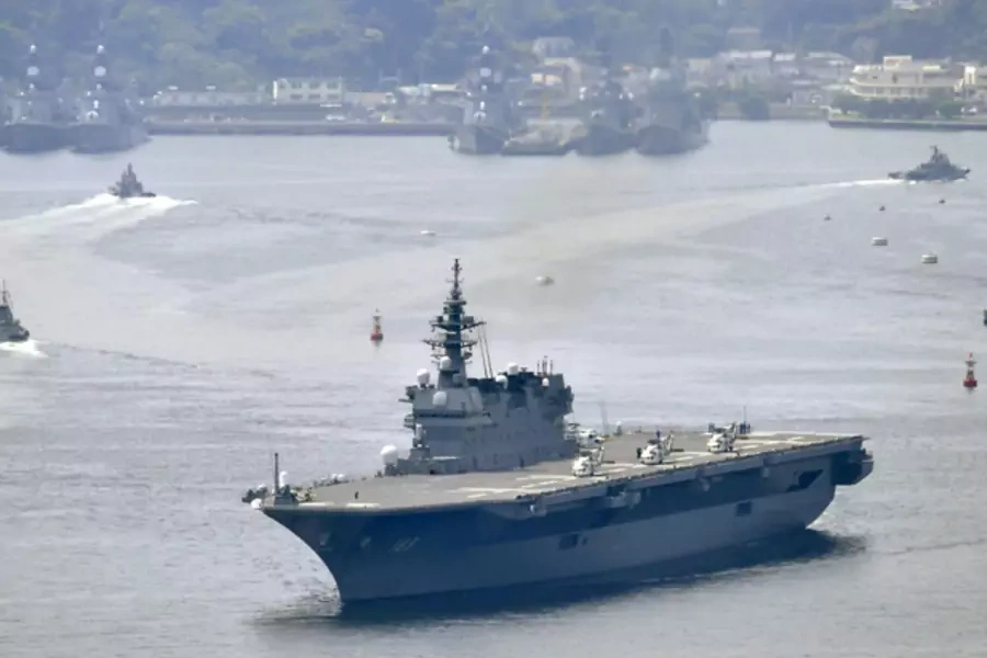 Japan's Maritime Self-defense Force helicopter carrier Izumo leaves Yokosuka base (background) in Kanagawa Prefecture, southwest of Tokyo in this photo taken by Kyodo on May 1, 2017. 