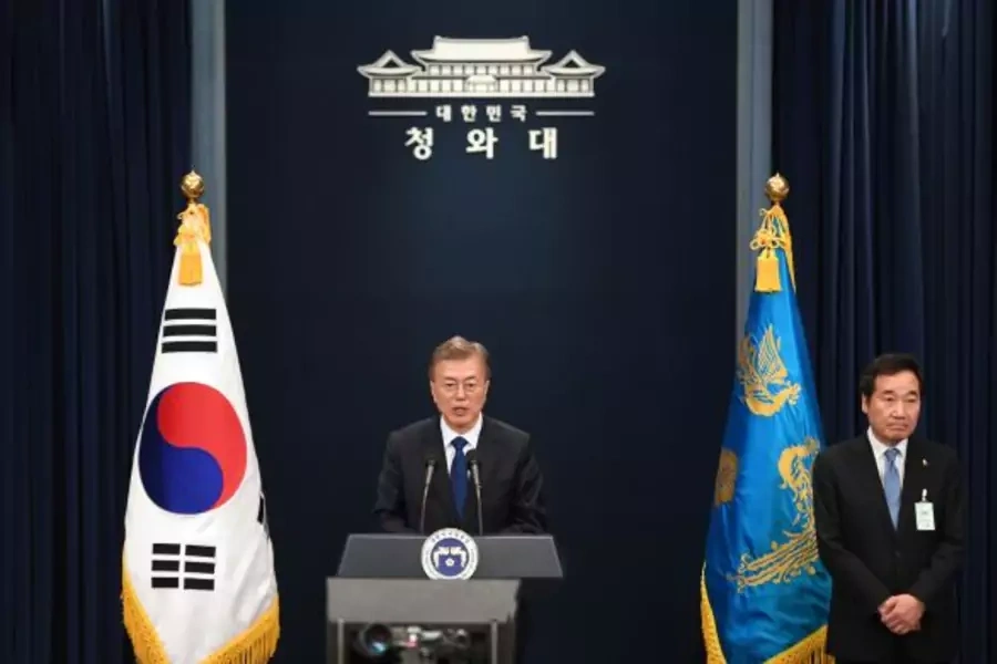 South Korea's new President Moon Jae-In speaks as Prime Minister nominee Lee Nak-Yon (R) listens to during a press conference at the presidential Blue House in Seoul on May 10, 2017.