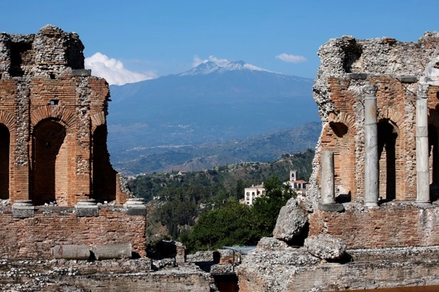 Etna volcano is seen from the Greek theatre in Taormina, Italy. 