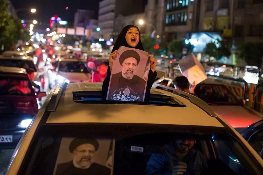A girl holds a poster of Iranian presidential candidate Ebrahim Raisi during a campaign rally in Tehran, Iran. 