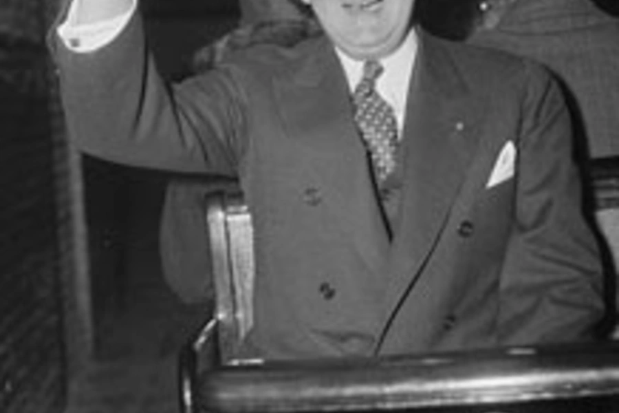 Senator Arthur H. Vandenberg salutes the camera man as he uses the tram for the trip from the Senate Office building to Capitol. (Harris & Ewing/courtesy Library of Congress)