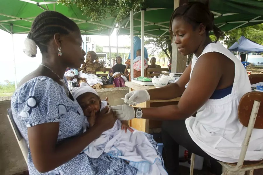 A nurse makes an injection to a baby at a maternity hospital in Treichville, Abidjan May 28, 2015. 
