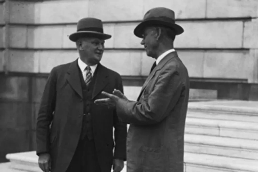 Representative Willis G. Hawley (R-OR) and Senator Reed Smoot (R-UT) on the steps of the Senate office building