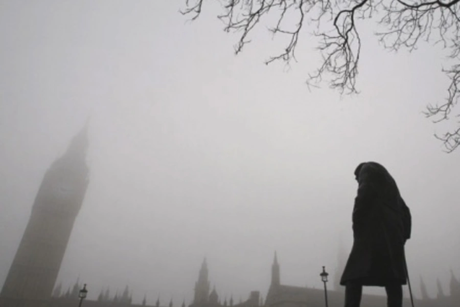 A statue of Winston Churchill stands outside the Houses of Parliament in London.