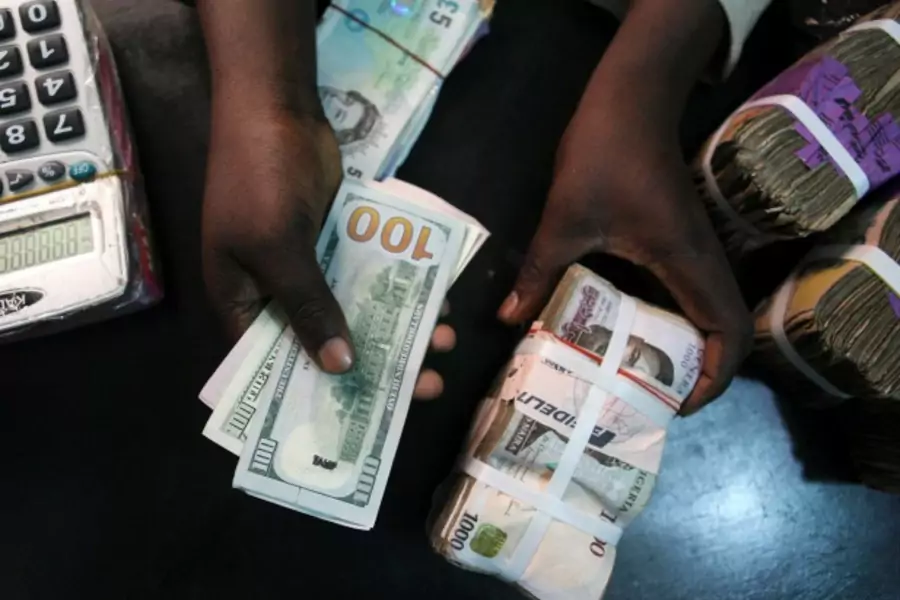 A trader changes dollars for Naira at a currency exchange store in Lagos, February 12, 2015.