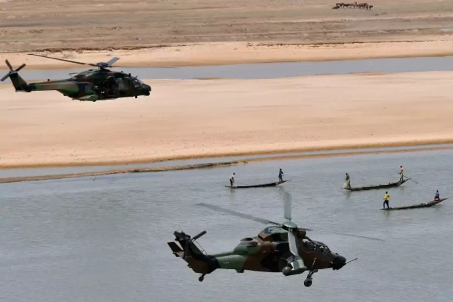 French President Emmanuel Macron's helicopter (upper) flies over Gao as he visits French troops in Africa's Sahel region in Gao, northern Mali, 19 May 2017.