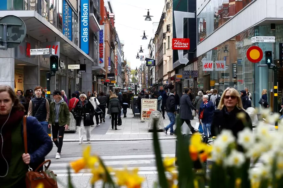 People walk through the shopping area on the pedestrian street Drottninggatan in Stockholm, Sweden.