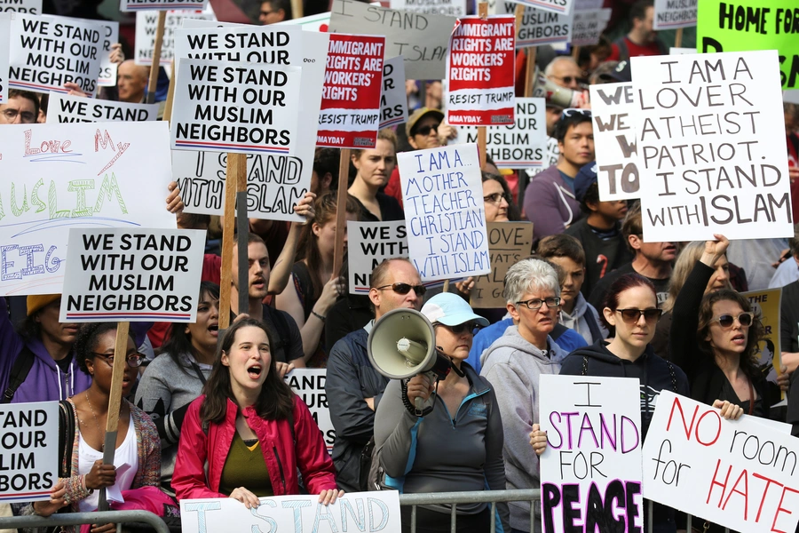 Counter-protesters hold signs and shout slogans during an anti-Sharia rally in Seattle.