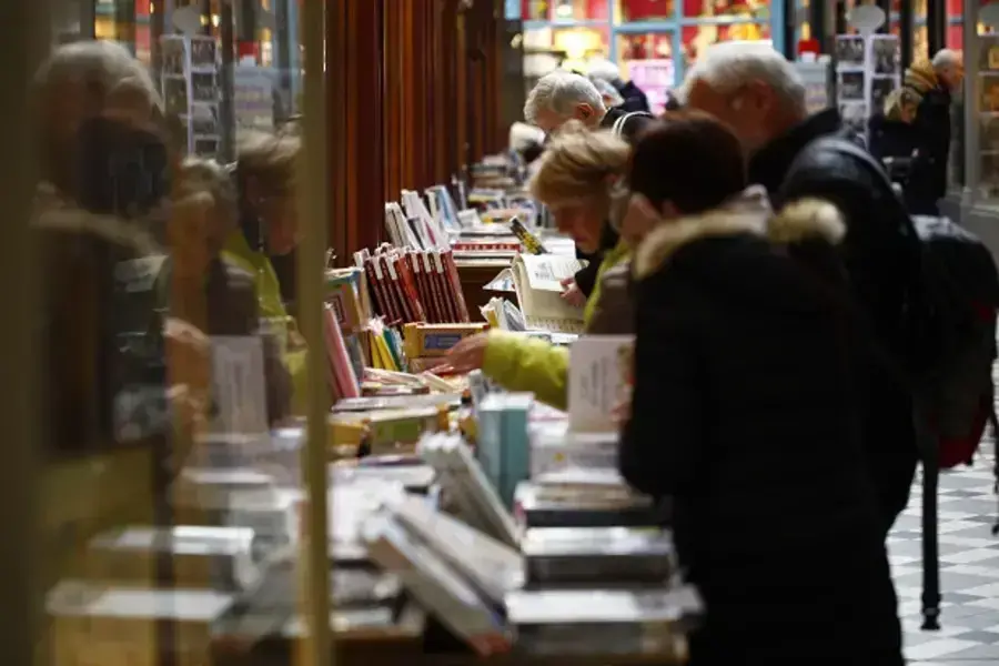 Shoppers peruse books in the Passage Jouffroy in Paris