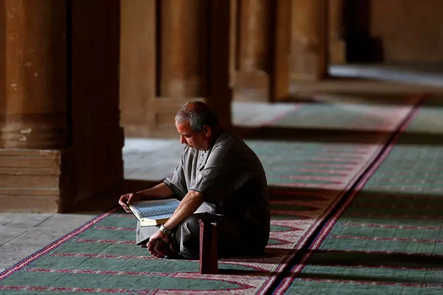 An Egyptian man reads the Koran during the first Friday of the holy month of Ramadan at Ibn Tulun Mosque in old Cairo (Amr Abdallah Dalsh/Reuters).