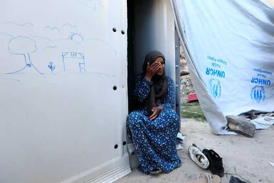Aanoud from Deir Ezzor in Syria sits beside her shelter at the Souda refugee camp in Chios Island, Greece, June 10, 2017. 