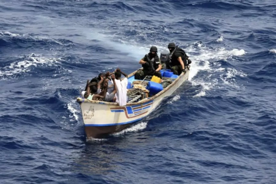 Marines from NATO's Portuguese frigate Corte-Real arrest pirates on their skiff in the Gulf of Aden June 22, 2009.