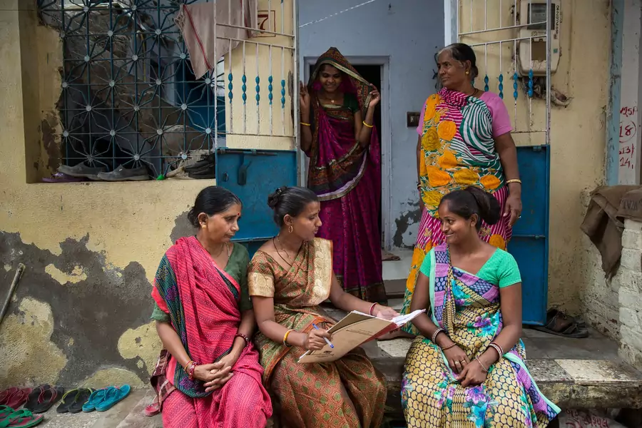 Women gather outside their homes in Ahmedabad, India to discuss work issues. As organized home-based workers, the women associated are with the Self Employed Women's Association (SEWA).