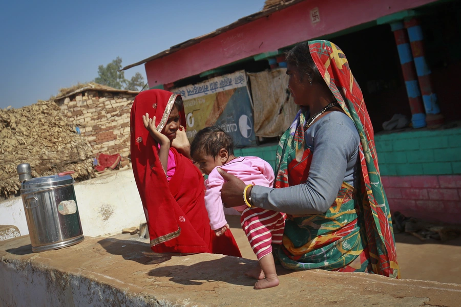 Krishna, 14, holds her four-month-old baby at her house in a village near Baran, India. Krishna was married to her husband Gopal when she was 11. The legal age for marriage in India is 18, but marriages like these are common, especially in poor, rural are