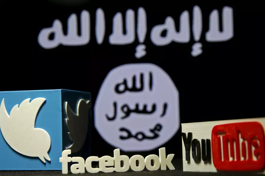 A 3D plastic representation of the Twitter and Youtube logo is seen in front of a displayed Islamic State group flag in this photo illustration.