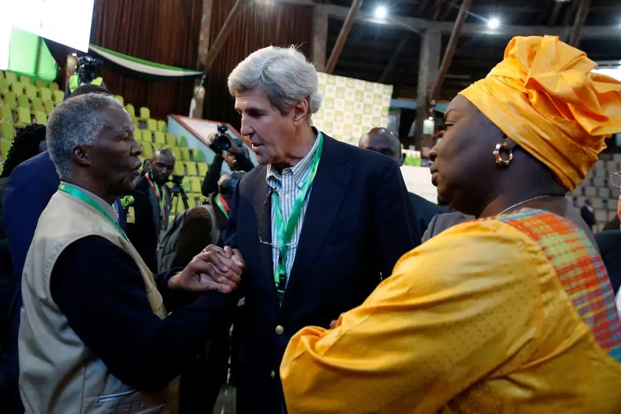 Former U.S. Secretary of State John Kerry and former South Africa President Thabo Mbeki, observers for the general election in Kenya, greet each other next to former Senegalese Prime Minister Aminata Toure in a tally centre in Nairobi early August 9, 2017