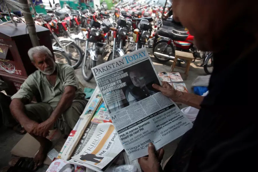 A man reads a newspaper with news about the disqualification of Pakistan's Prime Minister Nawaz Sharif by the Supreme Court, at a newsstand in Peshawar, Pakistan July 29, 2017.