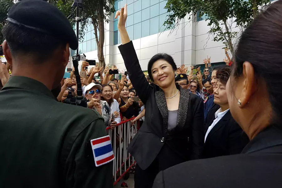 Ousted former Thai Prime Minister Yingluck Shinawatra greets supporters as she leaves the Supreme Court in Bangkok, Thailand, on August 1, 2017.