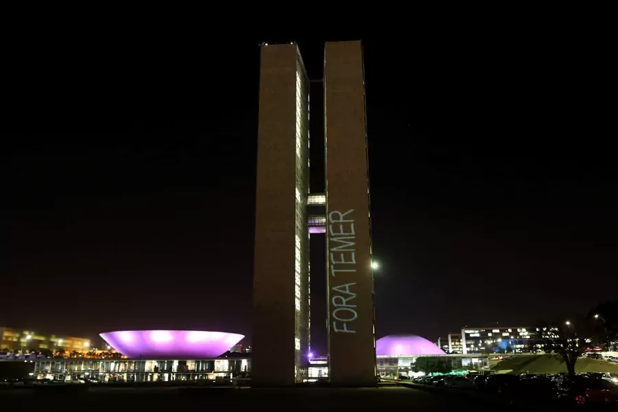 A projection with the message "Out Temer'' in reference of Brazilian President Michel Temer, is seen on the National Congress in Brasilia, Brazil August 1, 2017.