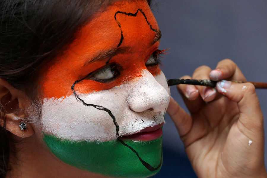 A girl gets her face painted in the colours of India's national flag, as she takes part in India's Independence Day celebrations inside a college in Chennai, India, August 15, 2017.