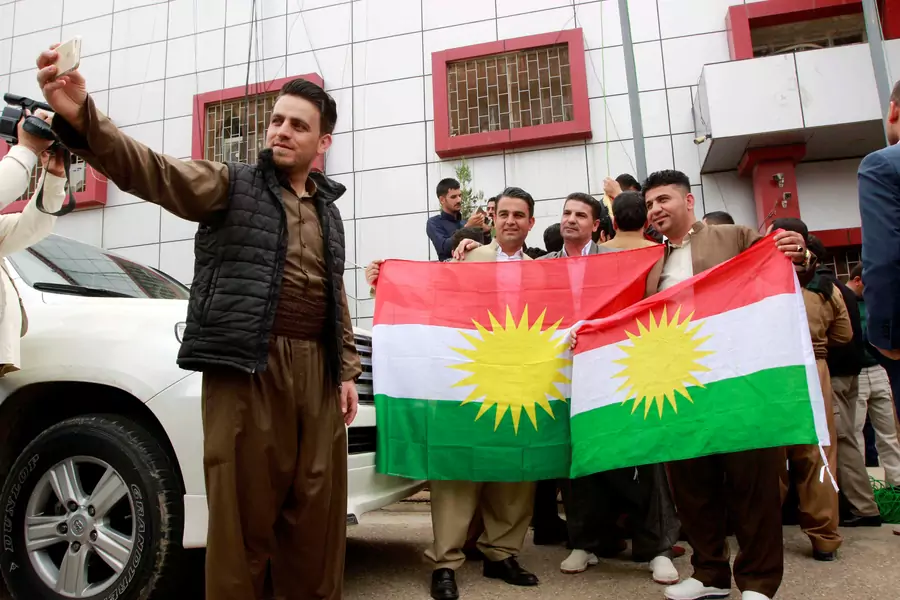 Kurdish parties take pictures with Kurdish flag at the Kirkuk Governorate Council in Kirkuk, Iraq (Ako Rasheed/Reuters).