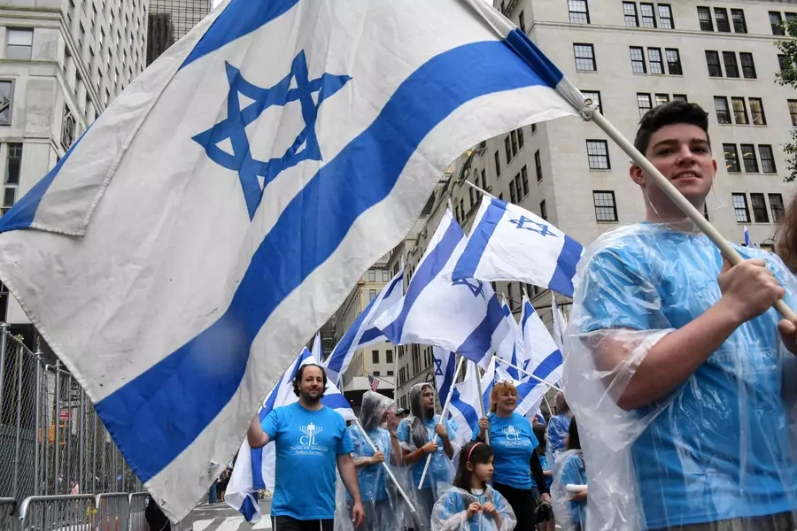 People carry Israeli flags while participating in the "Celebrate Israel" parade along 5th Ave. in New York City (Stephanie Keith/Reuters).