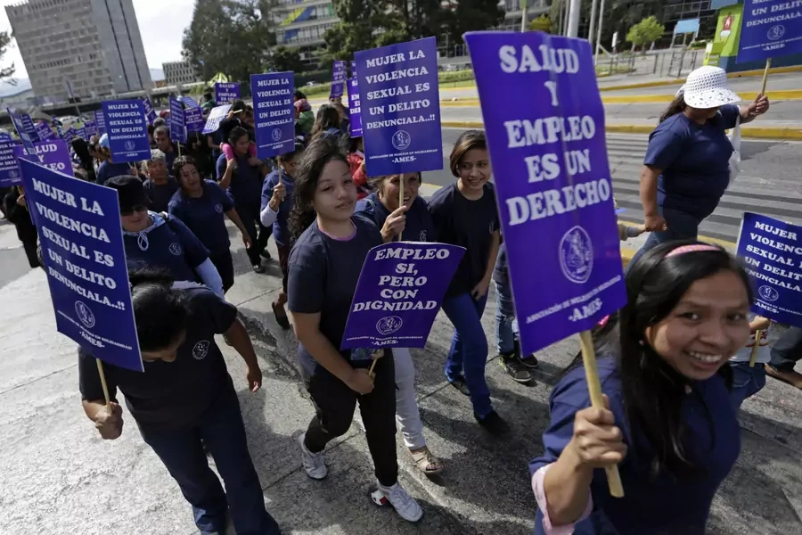 Women take part in a demonstration marking International Women's Day in Guatemala City March 8, 2015. The signs read, "Health and work are a right" (R) and "Work, yes, but with dignity" (C and L), "Denouncing sexual violence, crimes against women" (top C)