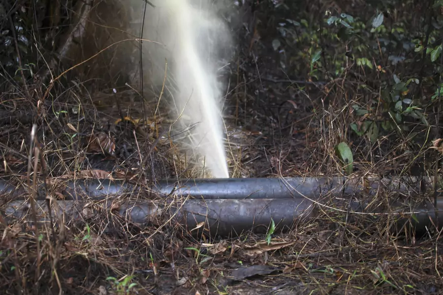 An oil pipeline spews oil after a leak in Nigeria's oil state of Bayelsa November 26, 2012. Thousands of people in Nigeria engage in a practice known locally as 'oil bunkering'—hacking into pipelines to steal crude then refining it or selling it abroad.
