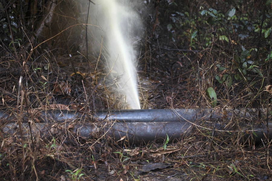 An oil pipeline spews oil after a leak in Nigeria's oil state of Bayelsa November 26, 2012. Thousands of people in Nigeria engage in a practice known locally as 'oil bunkering'—hacking into pipelines to steal crude then refining it or selling it abroad.