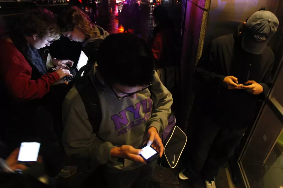People congregate near a building providing free wifi in the aftermath of Hurricaine Sandy in New York City in 2012. 