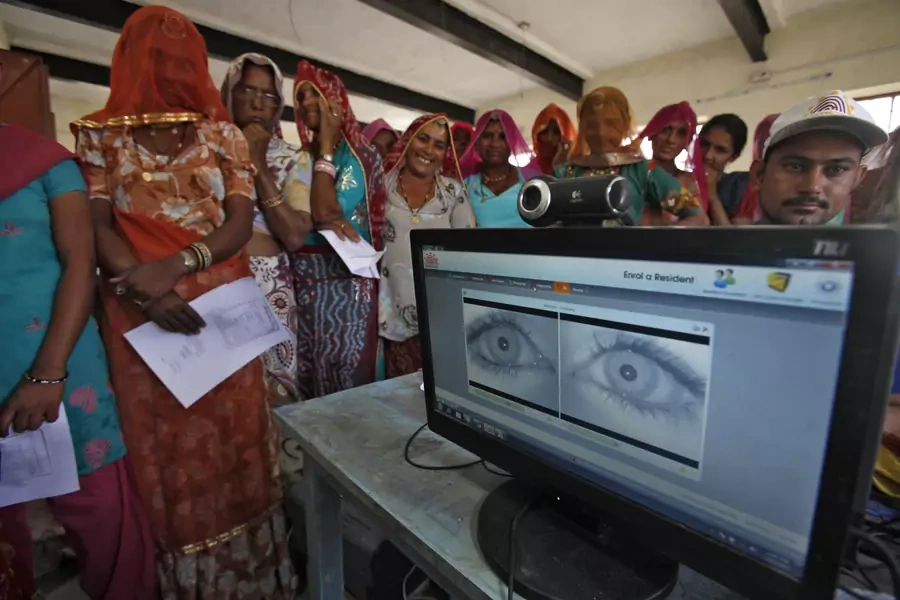 Village women stand in a queue to get themselves enrolled for Aadhaar, a controversial identification database in February 2013.