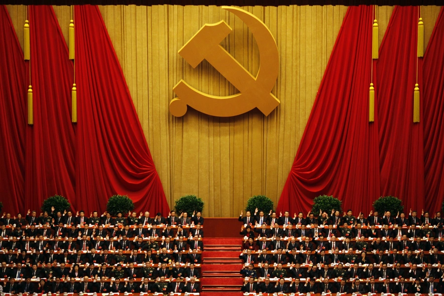 A general view shows delegates raising their hands as they take a vote at the closing session of the 18th National Congress of the Communist Party of China at the Great Hall of the People in Beijing November 14, 2012.