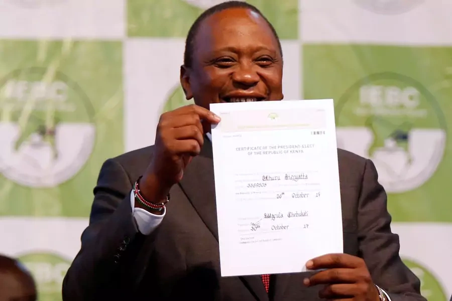 Incumbent President Uhuru Kenyatta holds the certificate of President-Elect of the Kenya after he was announced winner of the repeat presidential election at the IEBC National Tallying centre at the Bomas of Kenya, in Nairobi, Kenya October 30, 2017.