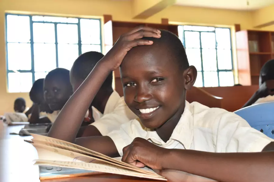 A fourth grade student at Kakenya Center for Excellence reads during English class. 
