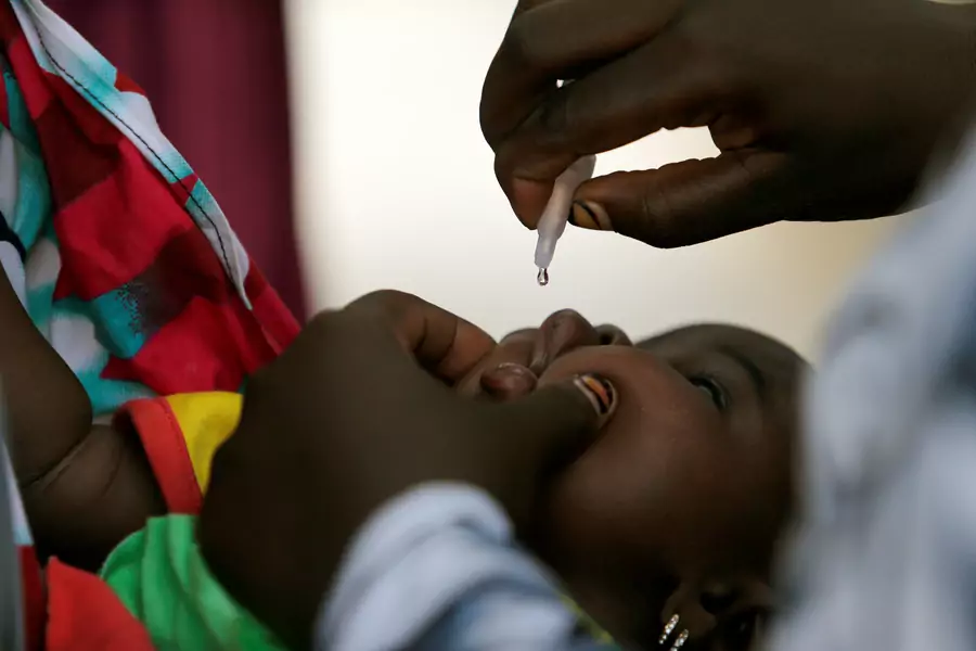 A child is given a dose of polio vaccine at an immunization health center, in Maiduguri, Borno State, Nigeria, August 29, 2016. Boko Haram has wrought immense destruction to Borno state and the greater Lake Chad basin.