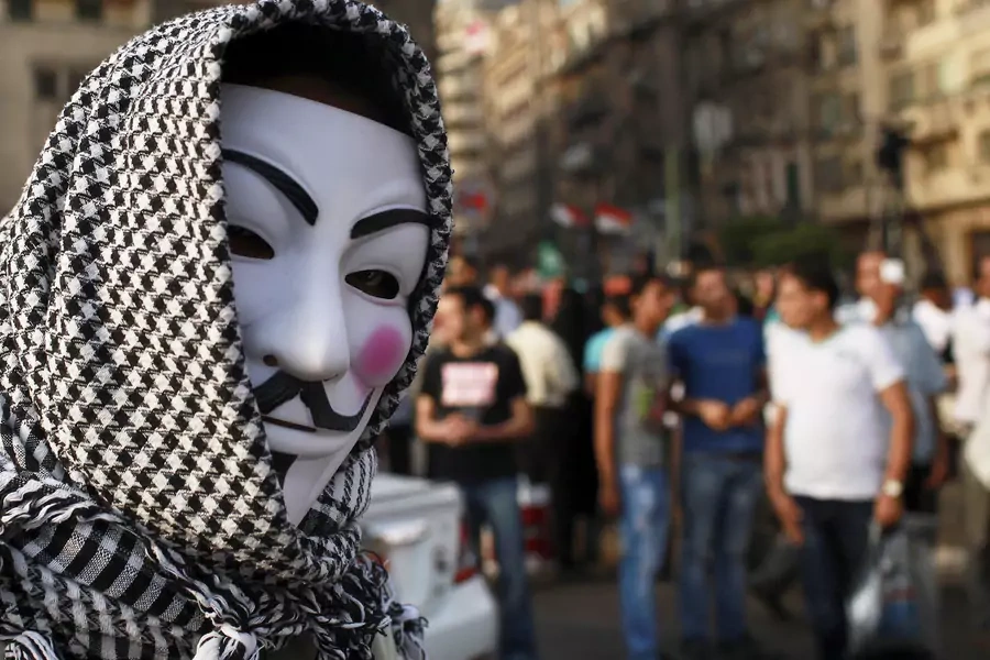 A protester wearing a Guy Fawkes mask attends a demonstration against presidential candidates Mohamed Mursi and Ahmed Shafiq at Tahrir Square in Cairo May 29, 2012. 