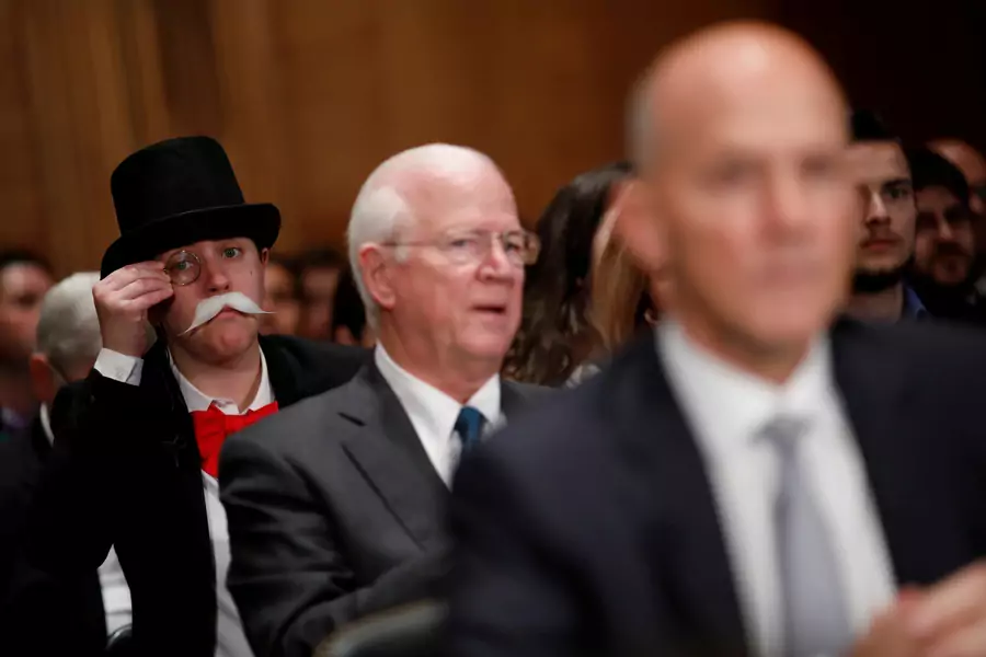 A hearing attendee looks on as Richard Smith, former chairman and CEO of Equifax, Inc., testifies before the U.S. Senate Banking Committee on Capitol Hill on October 4, 2017.