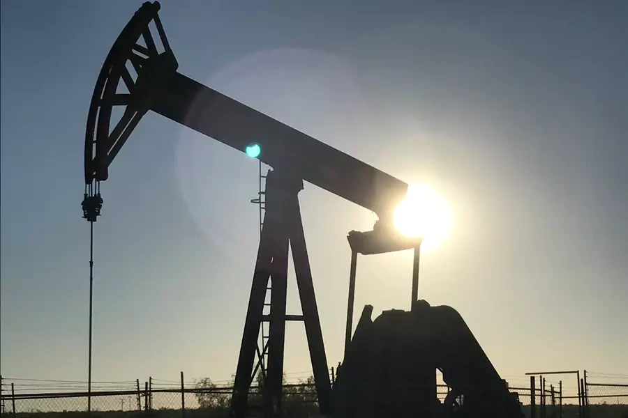 An oil rig drilling a well at sunrise near Midland, Texas