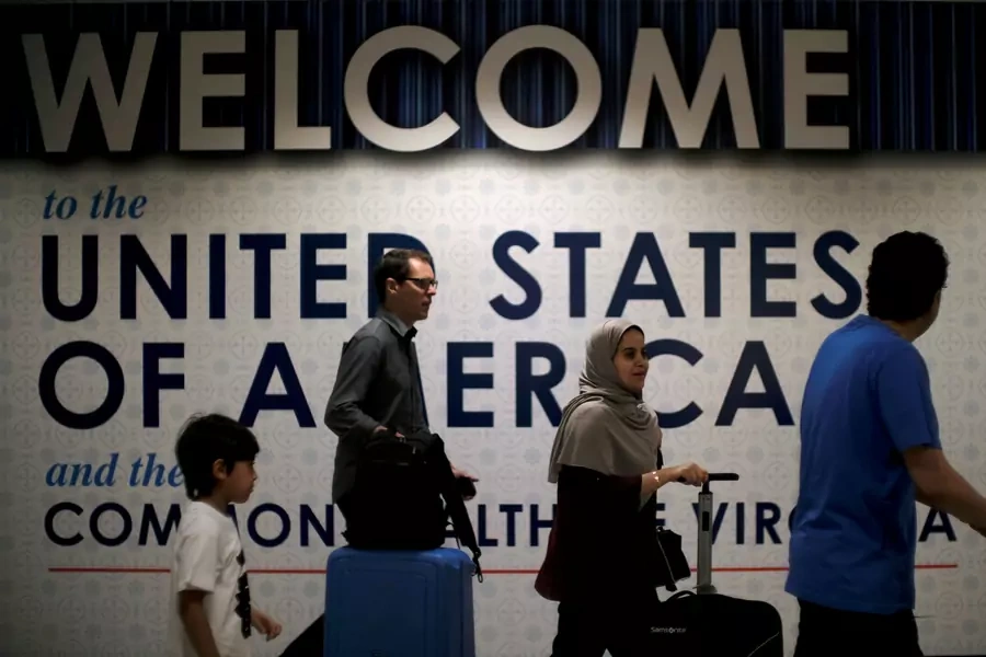 International passengers arrive at Washington Dulles International Airport after the U.S. Supreme Court granted parts of the Trump administration's emergency request to put its travel ban into effect in June, pending further judicial review 