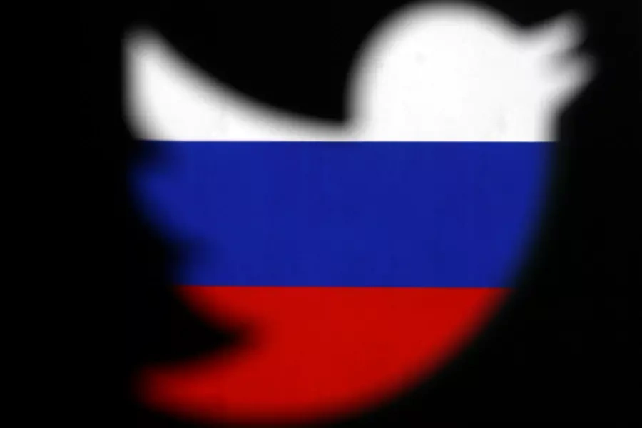 A 3D-printed Twitter logo displayed in front of Russian flag.