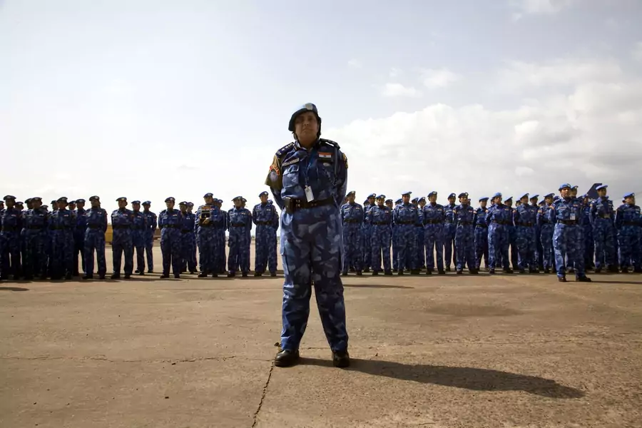 An Indian officer from the first all-female unit of United Nations peacekeepers stands in front of troops as they arrive at Roberts International Airport outside Liberia's capital Monrovia January 30, 2007. 