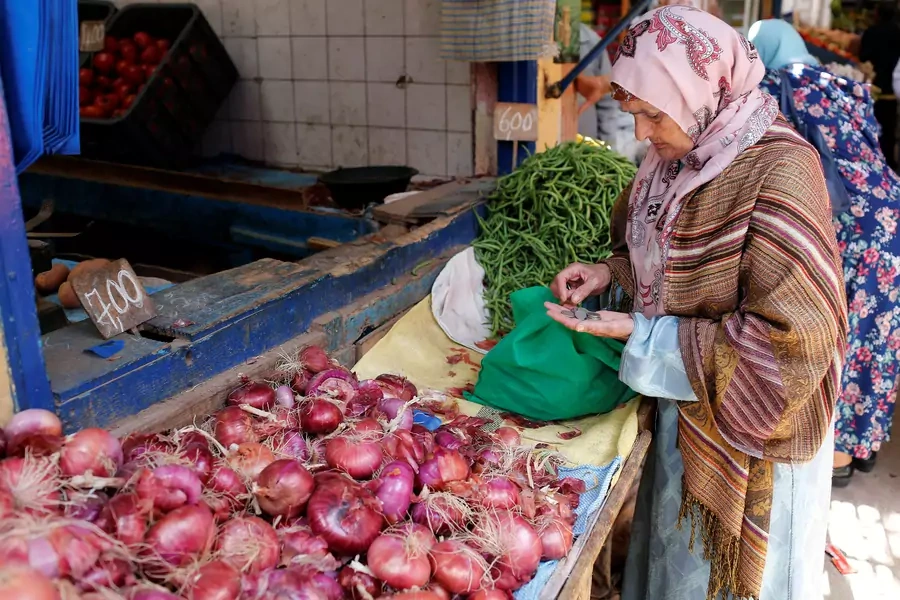 A women counts coins in a vegetable market in Casablanca, Morocco, June 29, 2017. Lawmakers have recently debated legislation that would legally protect women from harassment on streets and in public spaces.
